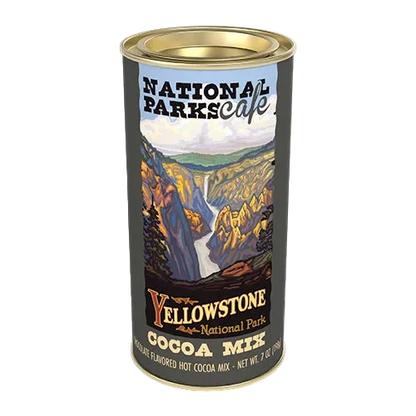 A cylindrical tin of Yellowstone National Park cocoa mix on a plain white background. The label features a scenic illustration of a canyon and waterfall with the text 'National Parks cafe' and 'Yellowstone National Park Cocoa Mix'.
